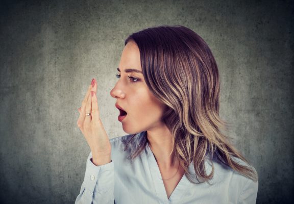 woman check for bad breath